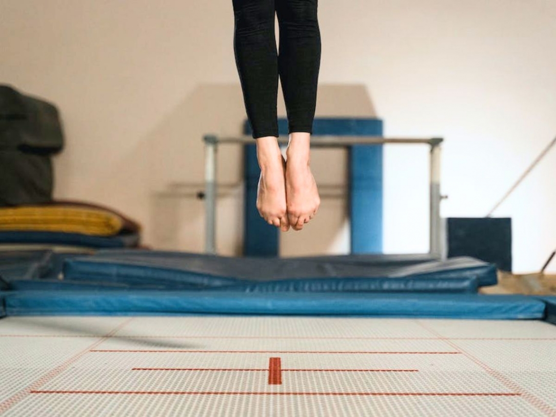 A female athlete on a gymnastics trampoline.jpg